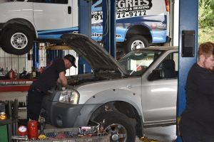 Mechanic with a clipboard checking car system — Greensboro, NC — Roy’s Automotive